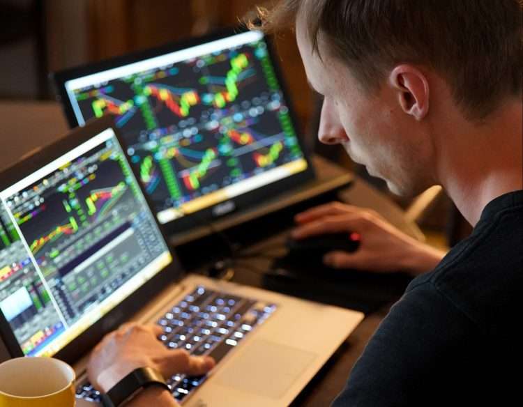 man sitting in front of the laptop