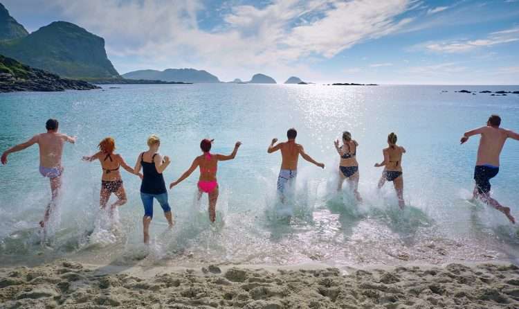 group of people playing on beach