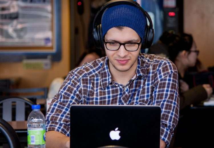 man using MacBook during daytime