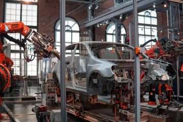 vehicle being fixed inside factory using robot machines