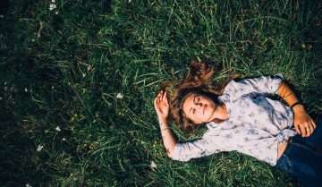 woman lying on grass dreaming