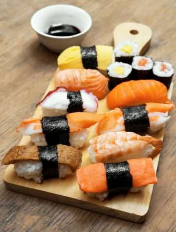food photography of varieties of sushies|sushi on wooden platter