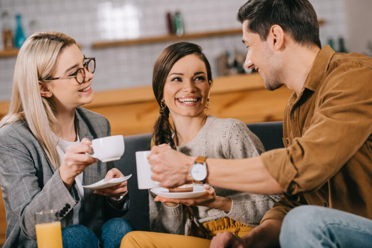 three people having a conversation and drinking tea