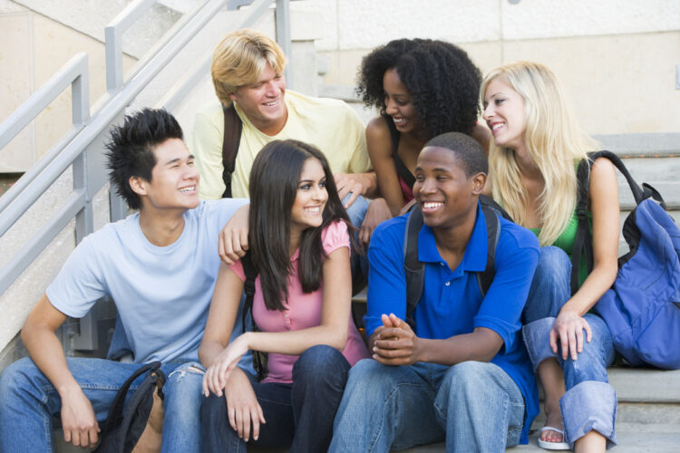 group of students talking on the steps